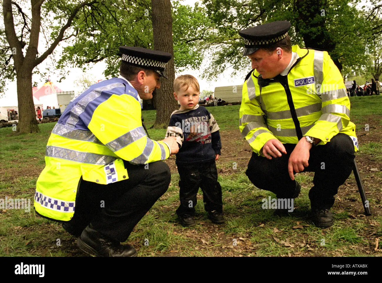 policemen-helping-a-lost-child-find-his-parents-at-a-festival-in-south-ATXABX